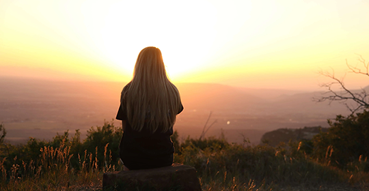 woman-looking-at-sunset-247195-e1603497064210